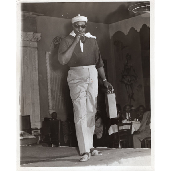 Man modeling with drink and briefcase, Sapphire Girls Women’s Club Fashion Show by Unknown