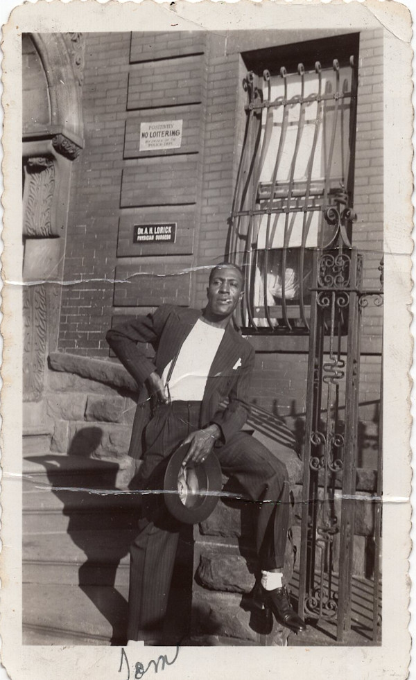 Tom posing outside physician’s office by Unknown