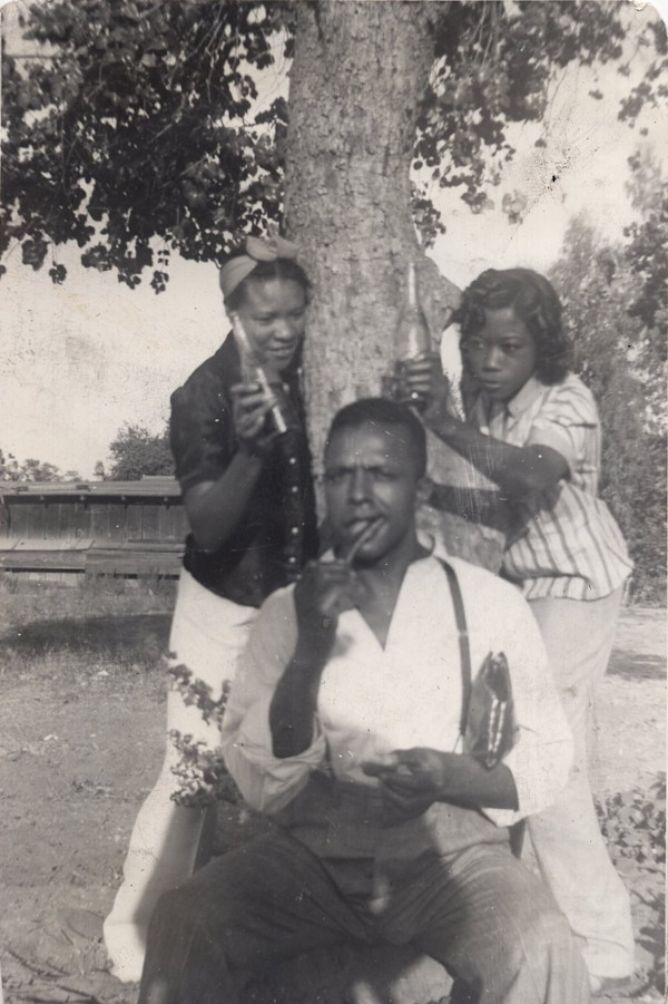 Trio goofing around a tree by Unknown