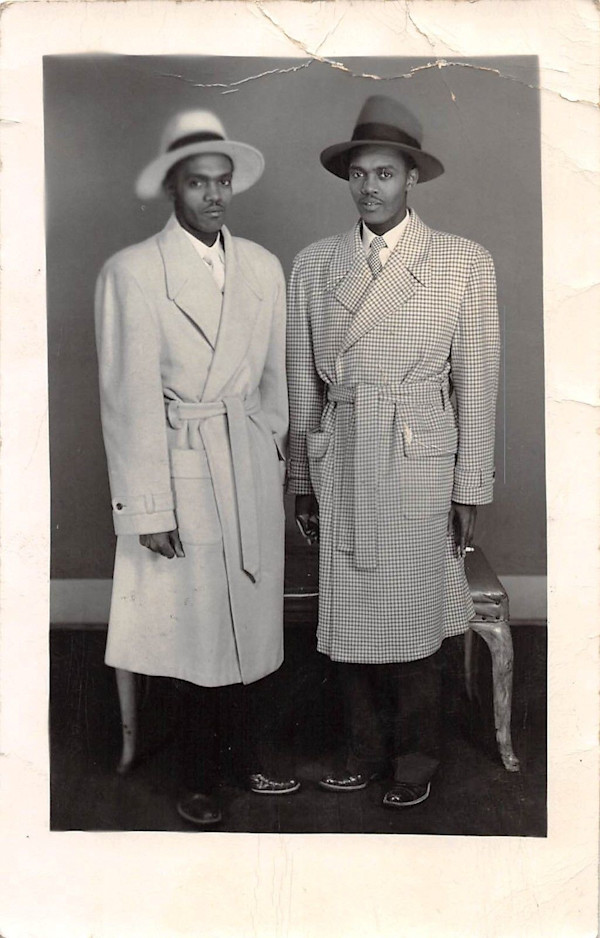 Twins in overcoats and hats by Unknown