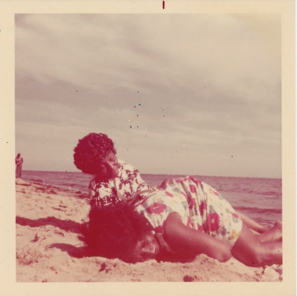 Two laughing women on beach by Unknown