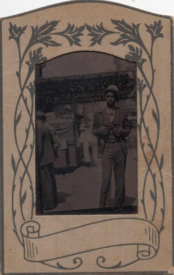 Well-dressed man near elevated tracks souvenir photo by Unknown