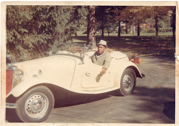 Man in white roadster by Unknown