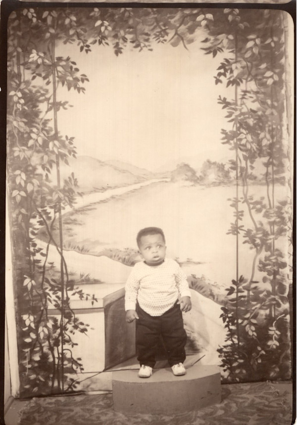 Boy with winding road backdrop by Unknown