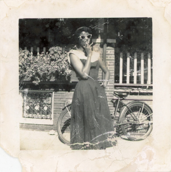 Smoking woman in sunglasses with bicycle by Unknown