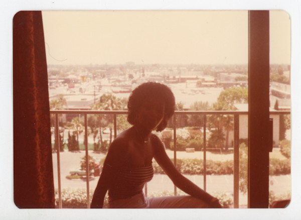 Woman in silhouette on balcony by Unknown