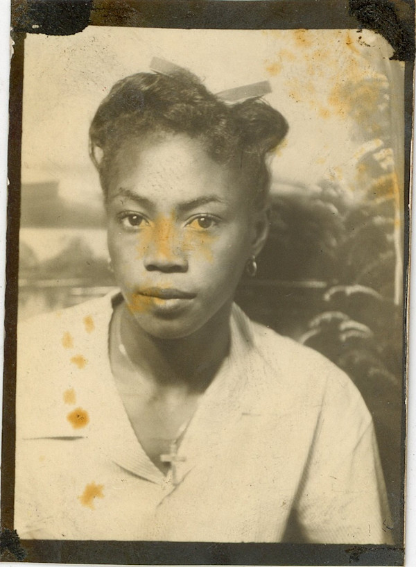 Woman with thin bow in hair and crucifix by Unknown