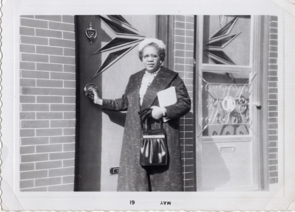 Woman at door by Unknown
