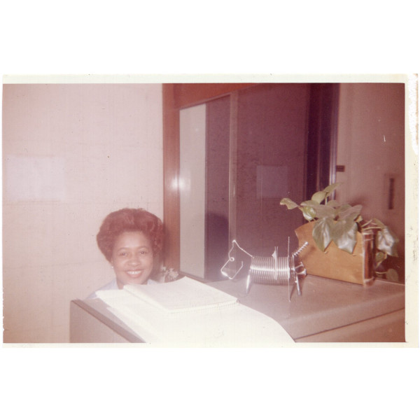 Woman hiding behind desk by Unknown