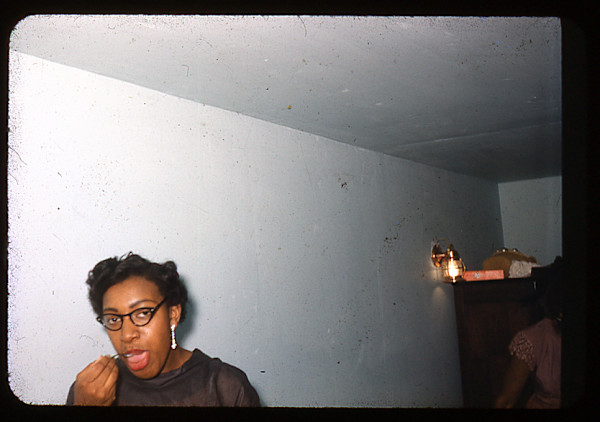 Woman in glasses, eating by Unknown
