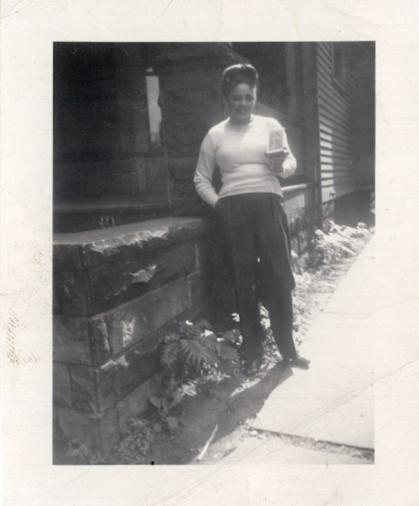 Woman holding photograph by Unknown