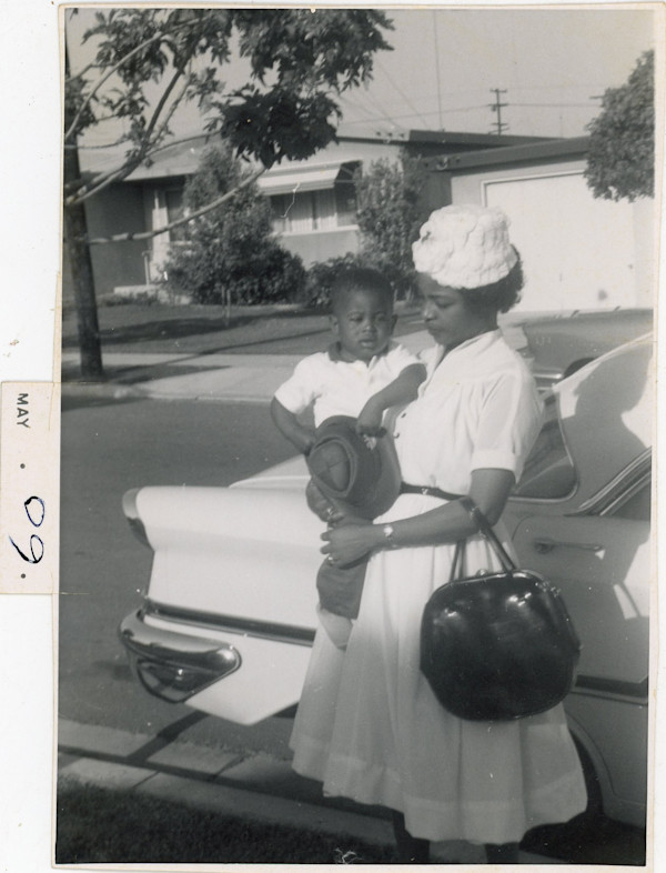 Woman holding toddler by Unknown