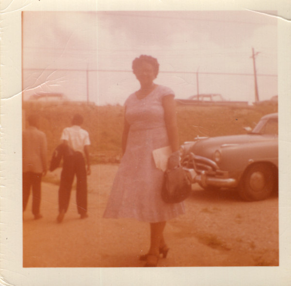 Woman in parking lot by Unknown