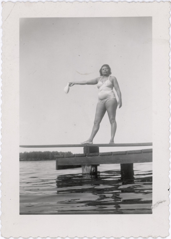 Woman in swimsuit on diving board by Unknown