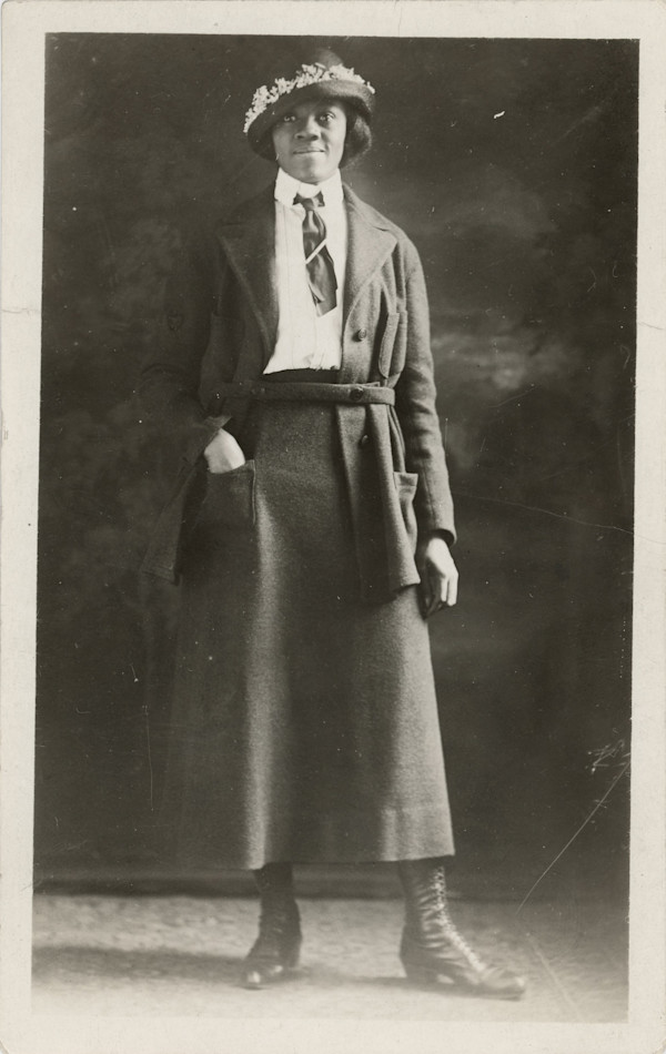 Dapper woman with hand in pocket by Unknown