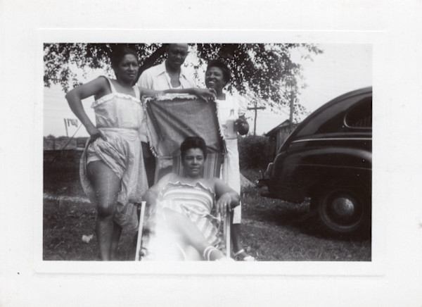One man & three women, one showing leg by Unknown