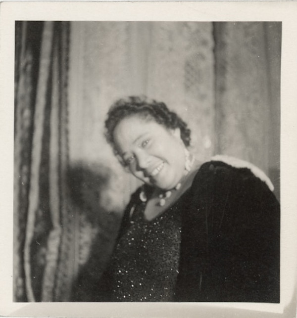Smiling woman in beaded dress by Unknown