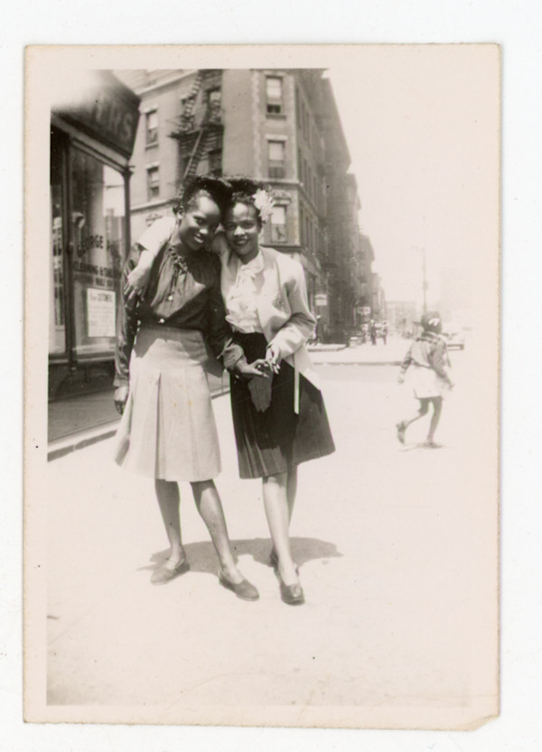 Two stylish young women on the avenue by Unknown