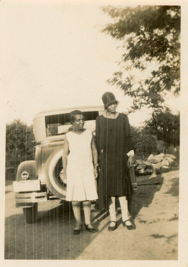 Tall woman and shorter woman by automobile by Unknown, Hicks Photo Finishers