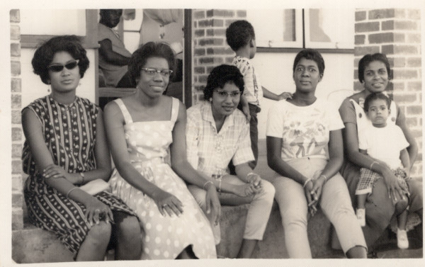 Five women on stoop with children by Unknown