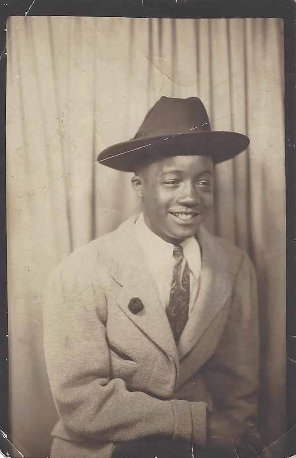 Smiling boy in fedora by Unknown
