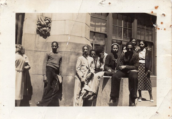 Group of young people outside building by Unknown