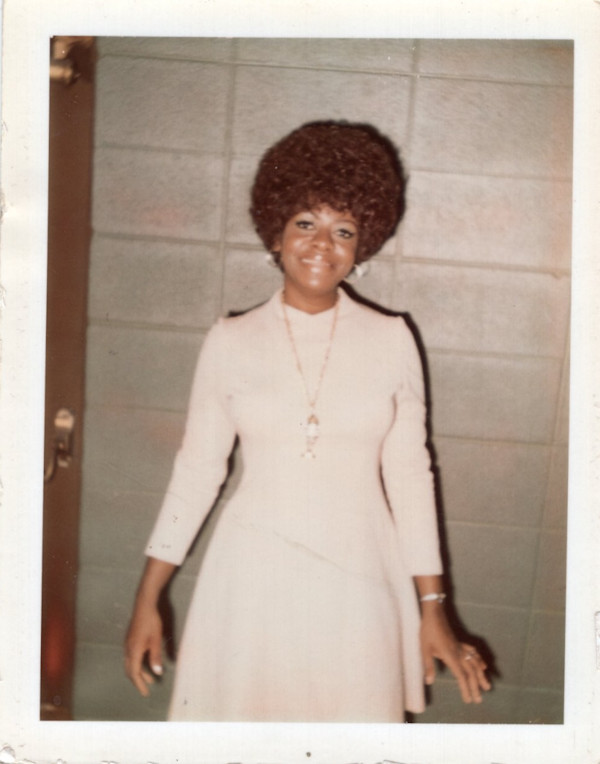 Woman with Afro and fish pendant by Unknown
