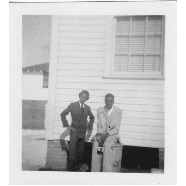 Two boys; one with camera by Unknown