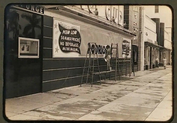 Sign painter outside nightclub by Unknown