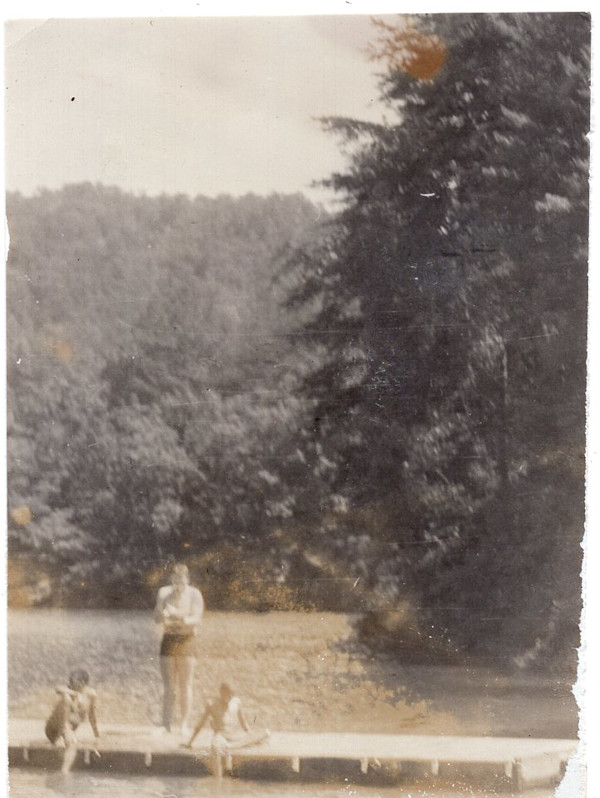 Boys sitting on dock by Unknown