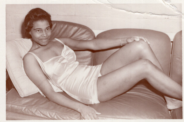 Woman reclining on sofa in full slip by Unknown