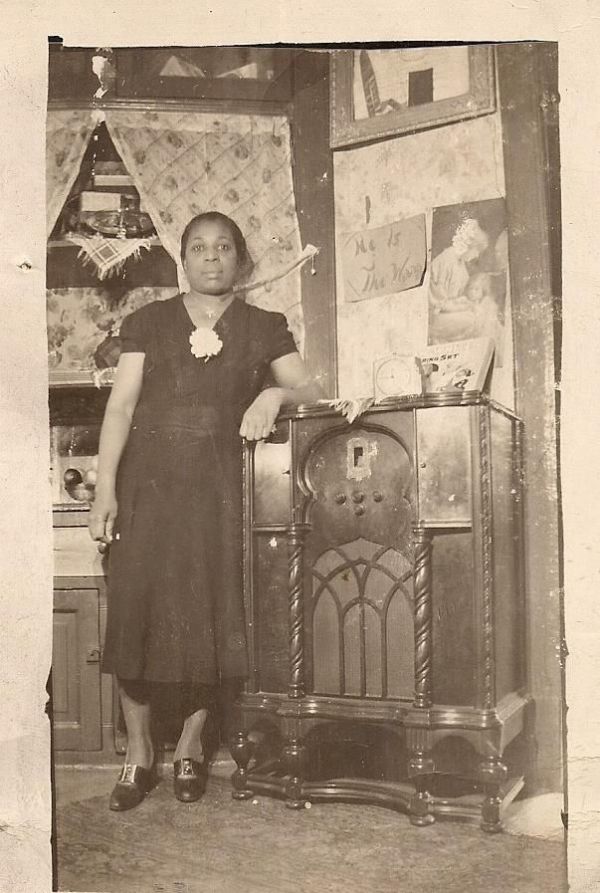 Woman standing next to radio, Chicago by Unknown