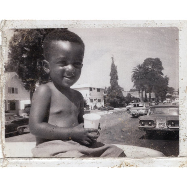 Boy holding cup, Los Angeles by Unknown