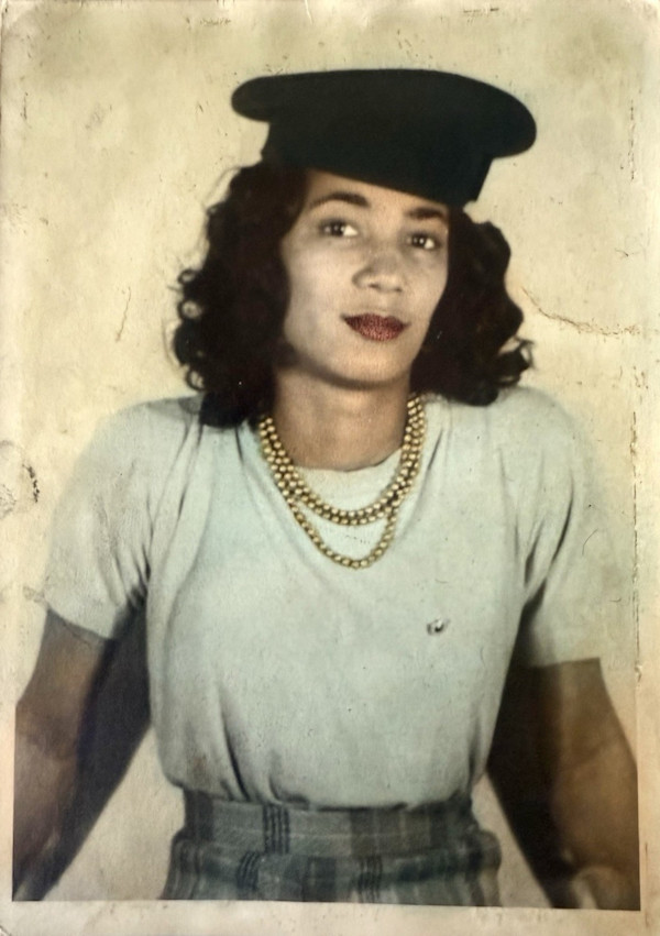 Woman in triple-strand necklace and hat by Unknown