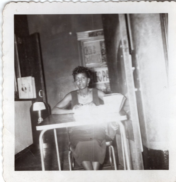 Woman seated at table by Unknown