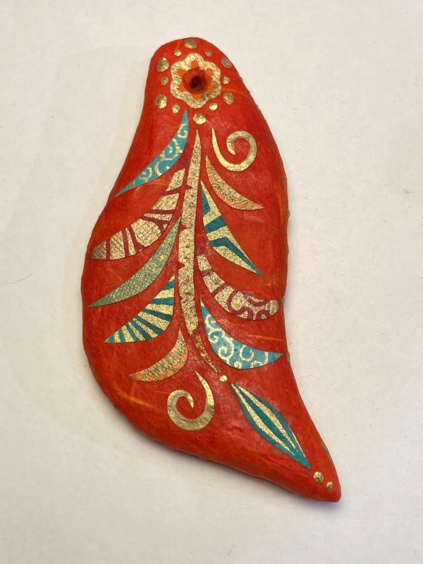 Red ornament with decorative swirls by Guylaine Gelinas