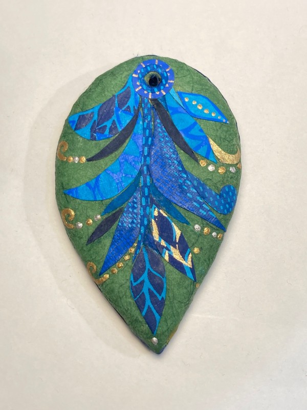 Green ornament with blue swirls by Guylaine Gelinas