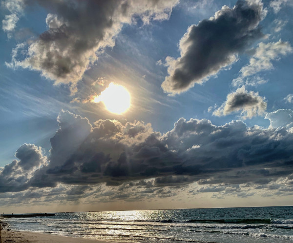 Sunset over the ocean by Anat Ambar