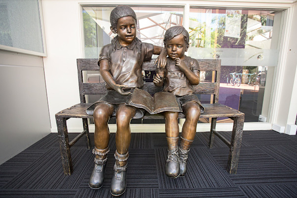 ‘Two children sitting on a bench’ by Kaviik Accents, USA.