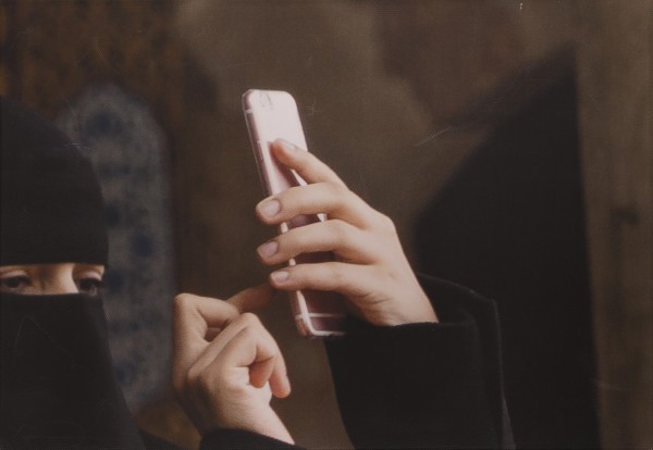 Covered Woman with iPhone, Istanbul by Helen Donis-Keller