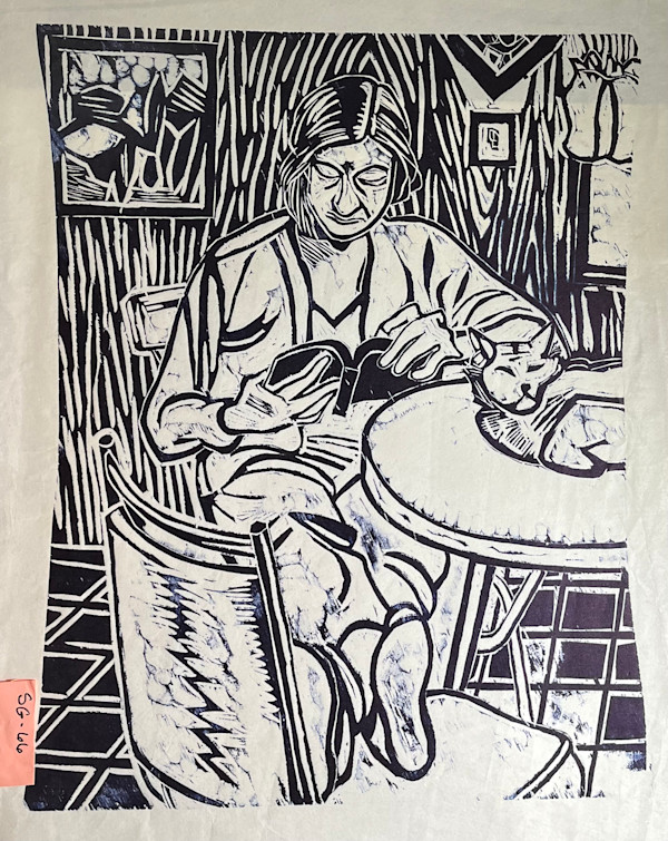 Deborah reading, with cat on the table. by Spence Guerin