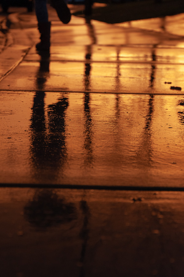 Running on a wet sidewalk at sunset by Kate Brogdon