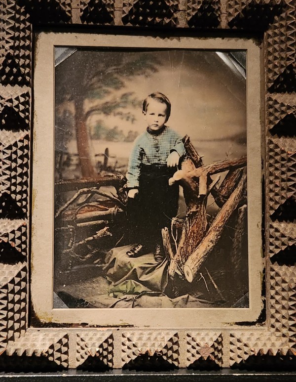 Boy with woodsy backdrop and props