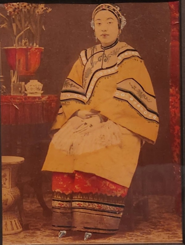 Chinese woman seated by table
