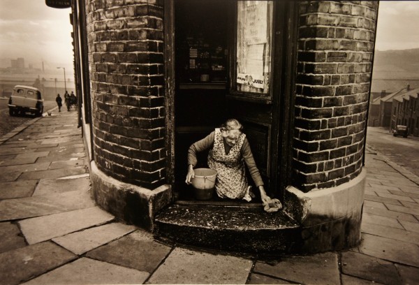 Shopkeeper Washing Doorstep, 1963 by Colin Jones