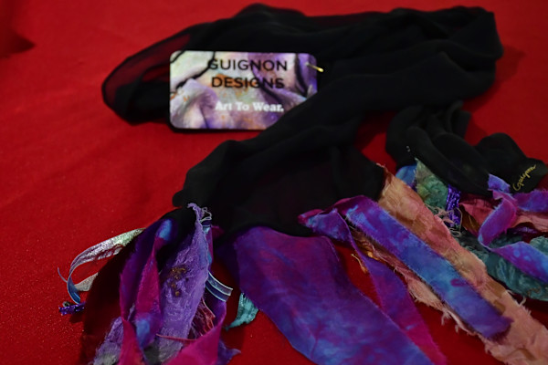 A black scarf with colorful silk ends by Grace Valery Guignon