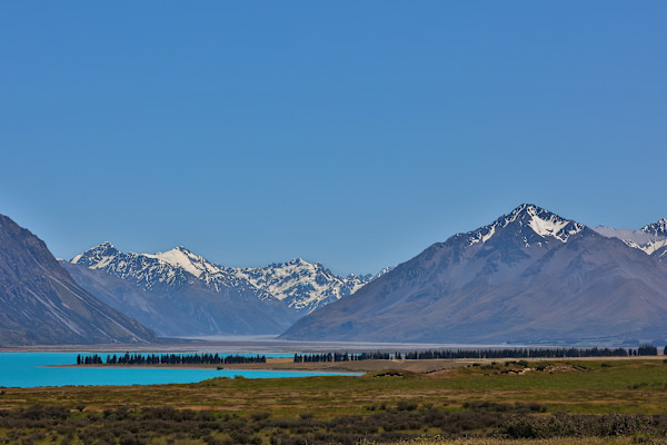 Tranquil lake beneath snowy peaks by EB Photography