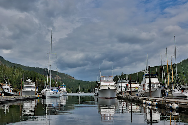 Boats resting under a cloudy sky by EB Photography