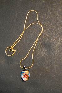 Fused dichroic glass basket shaped pendant on gold chain