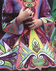 Girl holding hard shoes in crook of arm